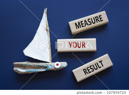 Measure your Result symbol. Concept words Measure your Result on wooden blocks. Beautiful deep blue background with boat. Business and Measure your Result concept. Copy space. 107959720