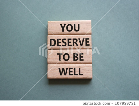 You deserve to be well symbol. Wooden blocks with words You deserve to be well. Beautiful grey green background. You deserve to be well concept. Copy space. 107959751