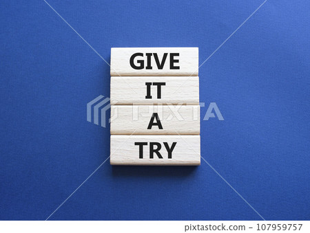Give it a try symbol. Concept words Give it a try on wooden blocks. Beautiful deep blue background. Business and Give it a try concept. Copy space. 107959757