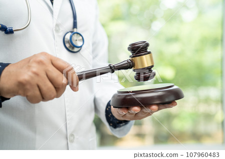 Doctor holding judge gavel, forensic medicine, medical law and crime justice concept. 107960483