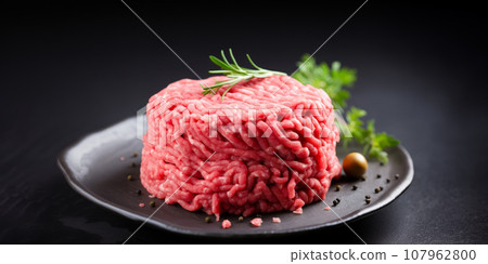 Fresh minced meat ground beef on a black plate. Fresh minced meat ground beef on a black plate. 107962800