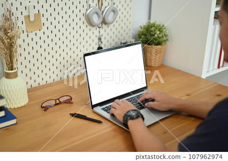 Cropped shot of young man hands typing on laptop surfing the internet or searching the information Cropped shot of young man hands typing on laptop surfing the internet or searching the information 107962974