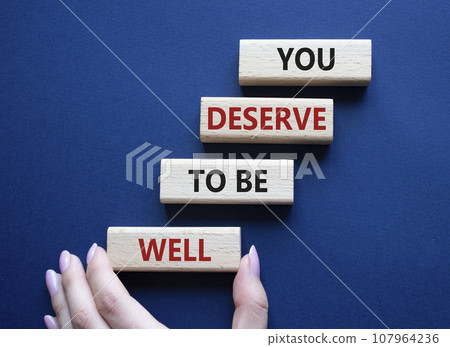 You deserve to be well symbol. Wooden blocks with words You deserve to be well. Beautiful deep blue background. Businessman hand. You deserve to be well concept. Copy space. You deserve to be well symbol. Wooden blocks with words You deserve to be well. Beautiful deep blue background. Businessman hand. You deserve to be well concept. Copy space. 107964236