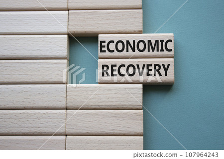 Economic recovery symbol. Concept words Economic recovery on wooden blocks. Beautiful grey green background. Business and Economic recovery concept. Copy space. 107964243