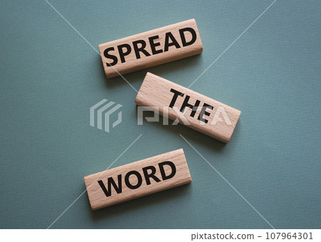 Spread the Word symbol. Concept wordsSpread the Word on wooden blocks. Beautiful grey green background. Business and Spread the Word concept. Copy space. 107964301