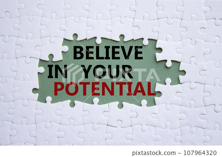 Potential symbol. Concept word Believe in your Potential on white puzzle. Beautiful grey green background. Business and Believe in your Potential concept. Copy space 107964320