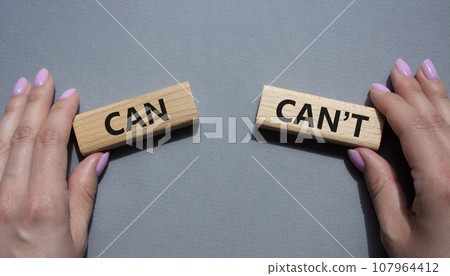 Can or Cant symbol. Concept word Can or Cant on wooden blocks. Businessman hand. Beautiful grey background. Business and Can or Cant concept. Copy space 107964412
