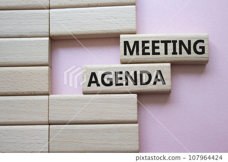 Meeting agenda symbol. Concept word Meeting agenda on wooden blocks. Beautiful pink background. Business and Meeting agenda concept. Copy space 107964424