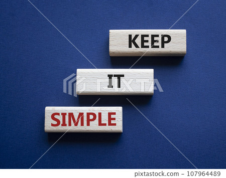 Keep it Simple symbol. Concept words Keep it Simple on wooden blocks. Beautiful deep blue background. Business and Keep it Simple concept. Copy space. 107964489