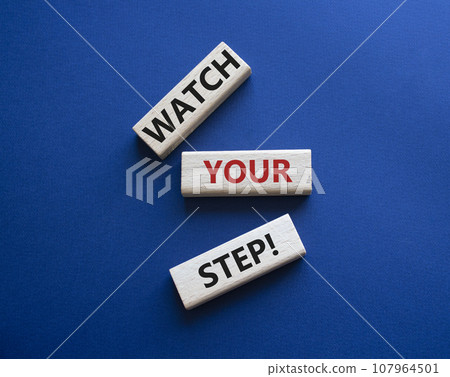 Watch your Step symbol. Concept words Watch your Step on wooden blocks. Beautiful deep blue background. Business and Watch your Step concept. Copy space. 107964501