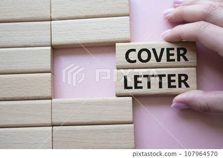 Cover Letter symbol. Concept word Cover Letter on wooden blocks. Businessman hand. Beautiful pink background. Business and Cover Letter concept. Copy space 107964570