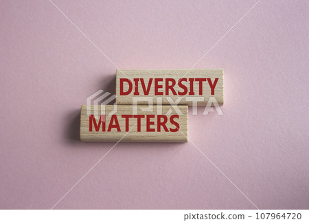 Diversity matters symbol. Wooden blocks with words Diversity matters. Beautiful pink background. Business and Diversity matters concept. Copy space. 107964720