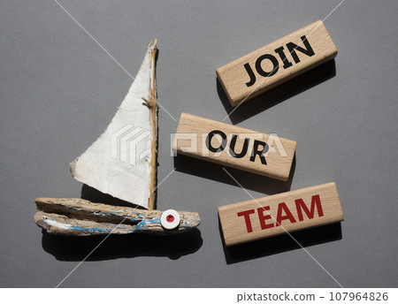 Join our team symbol. Wooden blocks with words Join our team. Beautiful grey background with boat. Business and Join our team concept. Copy space. 107964826