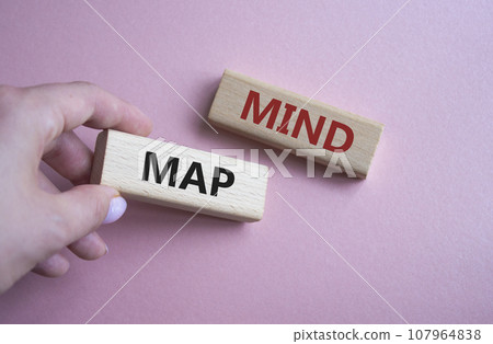 Mind Map symbol. Concept word Mind Map on wooden blocks. Businessman hand. Beautiful pink background. Business and Mind Map concept. Copy space Mind Map symbol. Concept word Mind Map on wooden blocks. Businessman hand. Beautiful pink background. Business and Mind Map concept. Copy space 107964838