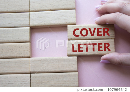 Cover Letter symbol. Concept word Cover Letter on wooden blocks. Businessman hand. Beautiful pink background. Business and Cover Letter concept. Copy space 107964842