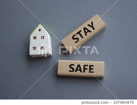 Stay Safe symbol. Concept word Stay Safe on wooden blocks. Beautiful grey background. Business and Stay Safe concept. Copy space 107964878