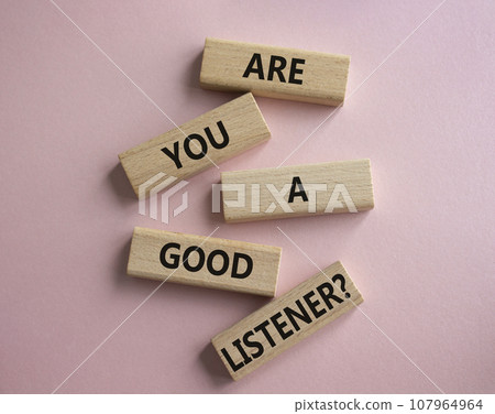 Listening skills symbol. Wooden blocks with words Are you a good Listener. Beautiful pink background. Business and Are you a good Listener concept. Copy space. 107964964