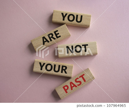 You are not your past symbol. Wooden blocks with words You are not your past. Beautiful pink background. Business and You are not your past. Copy space. 107964965