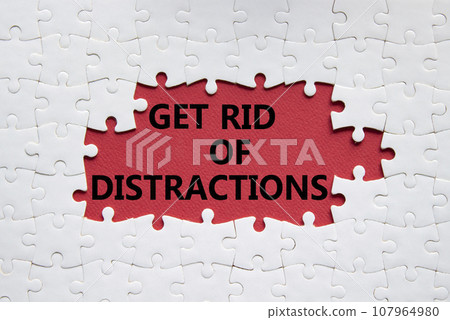 Distractions symbol. Concept word Get rid of Distractions on white puzzle. Beautiful red background. Business and Get rid of Distractions concept. Copy space Distractions symbol. Concept word Get rid of Distractions on white puzzle. Beautiful red background. Business and Get rid of Distractions concept. Copy space 107964980
