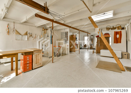 the inside of a room that is being used as an art studio for painting and other things to be displayed the inside of a room that is being used as an art studio for painting and other things to be displayed 107965269