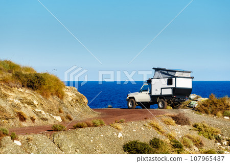 Off road vehicle with roof top tent camping on nature 107965487