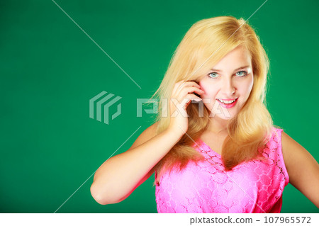 Happy smiling blonde woman in pink top Happy smiling blonde woman in pink top 107965572