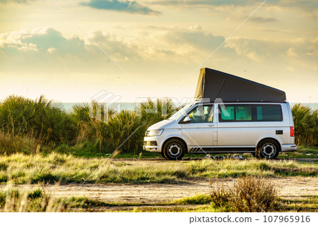 Van with roof top tent camping on nature Van with roof top tent camping on nature 107965916