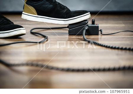 Man using guitar effects pedal Man using guitar effects pedal 107965951