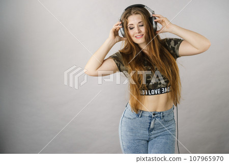 Teen women wearing headphones Teen women wearing headphones 107965970