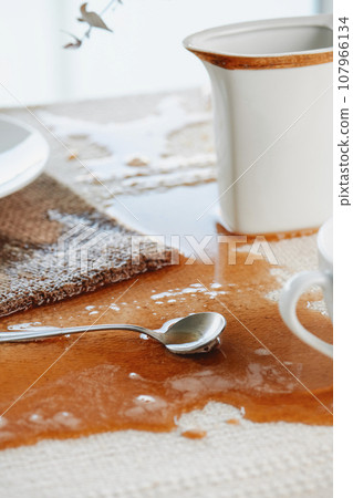 table with a puddle of coffee spilled accidentally 107966134