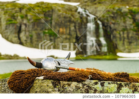 Viking helmet on lake shore, Norway 107966305