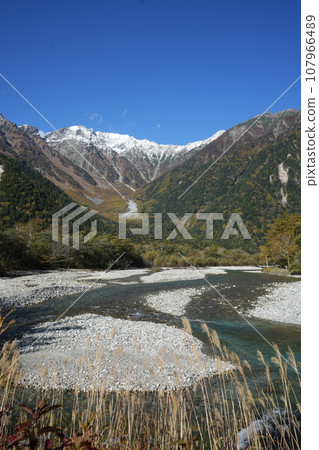 The Hotaka Mountain Range reflected in the Azusa River in late autumn The Hotaka Mountain Range reflected in the Azusa River in late autumn 107966489