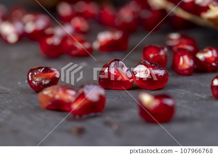 peeled red ripe pomegranate with red sweet grains 107966768