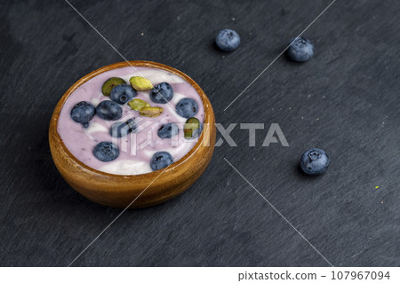 fresh purple and white yogurt with blueberries and blueberry berry flavor fresh purple and white yogurt with blueberries and blueberry berry flavor 107967094