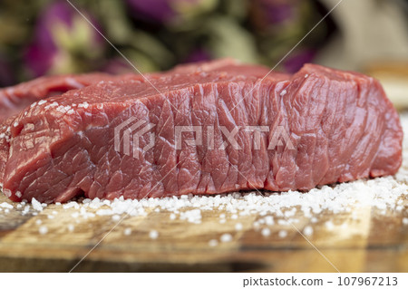 sliced piece of fresh raw beef during salting sliced piece of fresh raw beef during salting 107967213