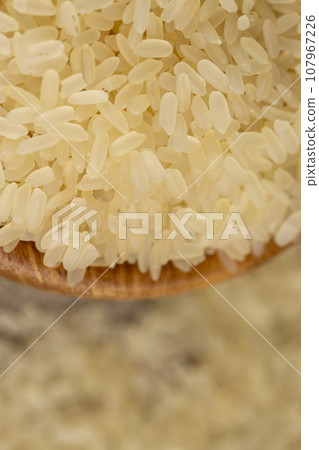 a large amount of uncooked fresh polished rice a large amount of uncooked fresh polished rice 107967226