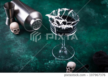 Halloween cocktail with spider cobweb 107967376