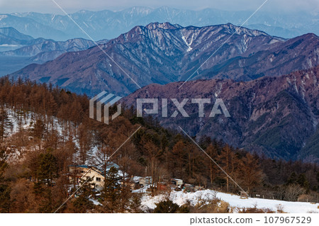 Mountain hut and Misaka mountain range seen from Mitsutoge and Mt. Kaiun in the morning Mountain hut and Misaka mountain range seen from Mitsutoge and Mt. Kaiun in the morning 107967529