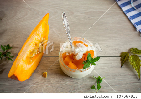 Homemade yogurt with pieces of pumpkin marmalade. 107967913