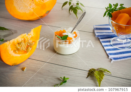 Homemade yogurt with pieces of pumpkin marmalade. 107967915