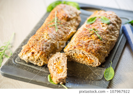 Cooked minced meatloaf with vegetable filling inside. Cooked minced meatloaf with vegetable filling inside. 107967922