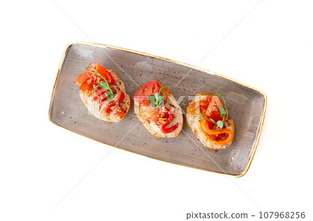Bruschetta with salmon gravlax and crunch onion on ciabatta toast isolated 107968256
