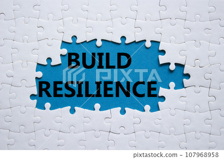 Build resilience symbol. White puzzle with words Build resilience. Beautiful blue background. Business and Build resilience concept. Copy space. 107968958