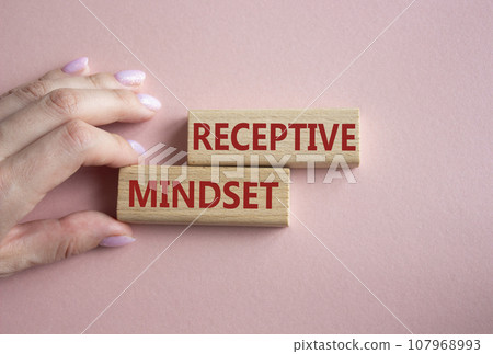 Receptive Mindset symbol. Concept word Receptive Mindset on wooden blocks. Businessman hand. Beautiful pink background. Business and Receptive Mindset concept. Copy space Receptive Mindset symbol. Concept word Receptive Mindset on wooden blocks. Businessman hand. Beautiful pink background. Business and Receptive Mindset concept. Copy space 107968993