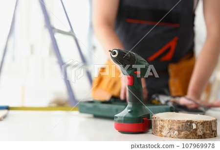 Arms of worker using electric drill Arms of worker using electric drill 107969978