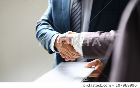 Man in suit shake hand as hello in office 107969990