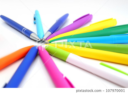 Multi colored ball pens on white background 107970001