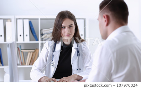 Beautiful smiling female doctor hold silver pen 107970024