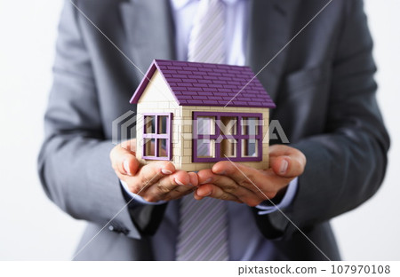 Man in suit and tie cover with arms little 107970108