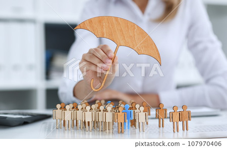 The female hand holds a miniature umbrella The female hand holds a miniature umbrella 107970406